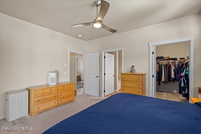 1232 W Grove Way, Coeur Dalene, ID 83815 - bedroom with light colored carpet, a textured ceiling, a ceiling fan, and a spacious closet