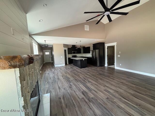 32926 N 10th Ave, Spirit Lake, ID 83869 - unfurnished living room featuring ceiling fan, dark wood-style floors, and high vaulted ceiling