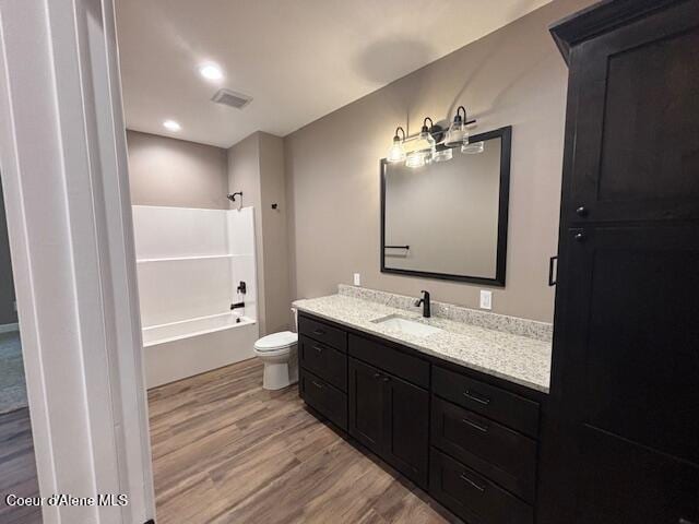 32926 N 10th Ave, Spirit Lake, ID 83869 - full bathroom featuring wood finished floors, vanity, and tub / shower combination