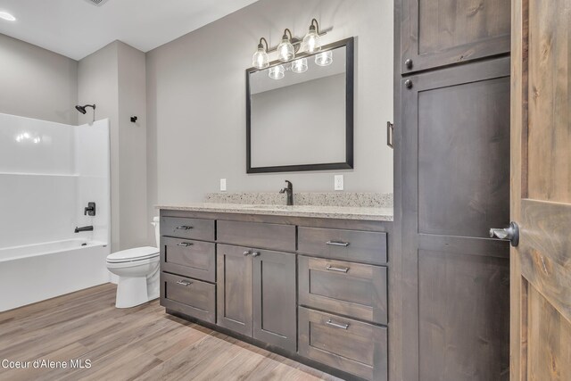 32926 N 10th Ave, Spirit Lake, ID 83869 - full bath featuring wood finished floors, vanity, and shower / bathtub combination