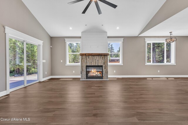 32926 N 10th Ave, Spirit Lake, ID 83869 - unfurnished living room with vaulted ceiling, a glass covered fireplace, ceiling fan, dark wood-style floors, and a chandelier