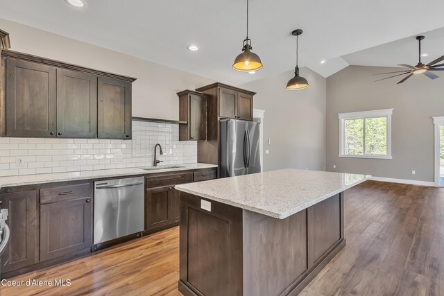 32926 N 10th Ave, Spirit Lake, ID 83869 - kitchen with appliances with stainless steel finishes, light wood finished floors, ceiling fan, dark brown cabinets, and vaulted ceiling