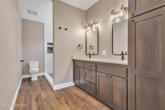 32926 N 10th Ave, Spirit Lake, ID 83869 - full bathroom with double vanity, wood finished floors, and tiled shower