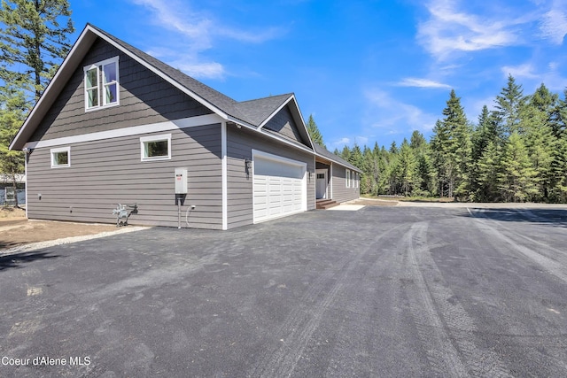 32926 N 10th Ave, Spirit Lake, ID 83869 - view of property exterior featuring asphalt driveway and a garage