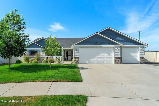 6487 W Covenant St, Rathdrum, ID 83858 - craftsman-style house featuring stone siding, a garage, and driveway