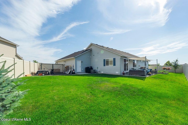6487 W Covenant St, Rathdrum, ID 83858 - back of property with outdoor lounge area, a fenced backyard, and a patio