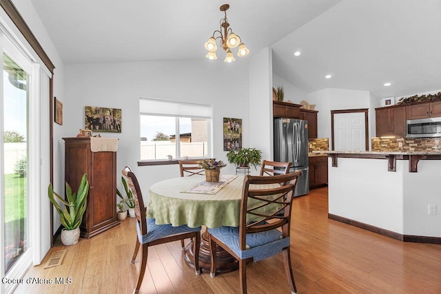 6487 W Covenant St, Rathdrum, ID 83858 - dining room with light wood-style flooring, vaulted ceiling, a chandelier, and recessed lighting