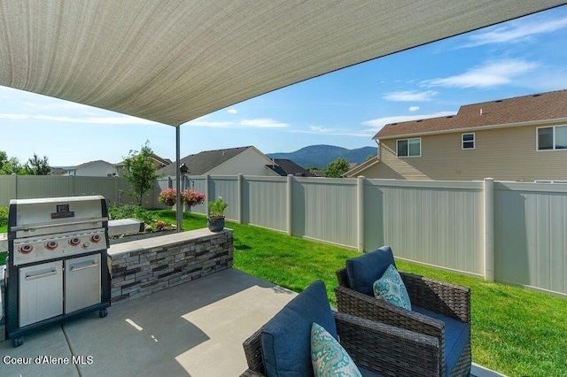 6487 W Covenant St, Rathdrum, ID 83858 - fenced backyard with a patio area, a mountain view, and grilling area