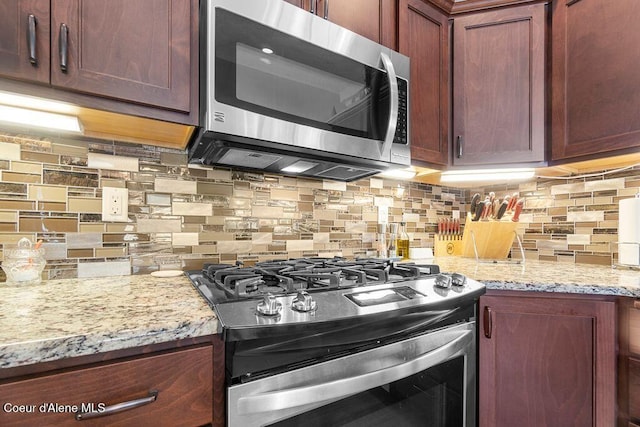 6487 W Covenant St, Rathdrum, ID 83858 - kitchen with stainless steel appliances, backsplash, and light stone counters