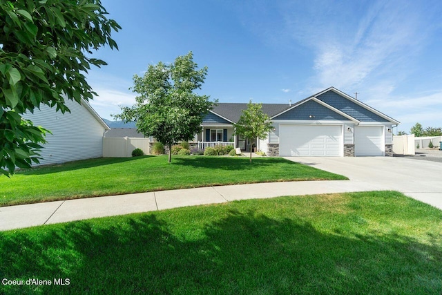 6487 W Covenant St, Rathdrum, ID 83858 - view of front of property with a garage, concrete driveway, and stone siding