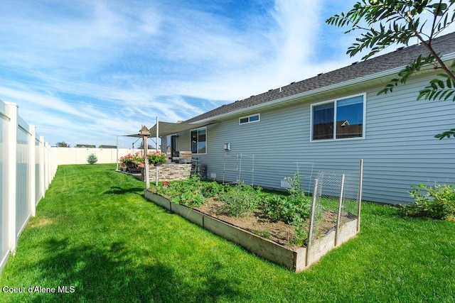 6487 W Covenant St, Rathdrum, ID 83858 - view of side of home with a vegetable garden and a fenced backyard