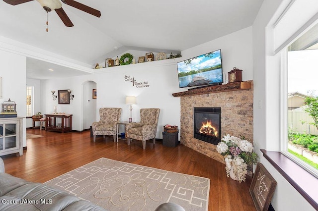 6487 W Covenant St, Rathdrum, ID 83858 - living area featuring arched walkways, lofted ceiling, plenty of natural light, and wood finished floors