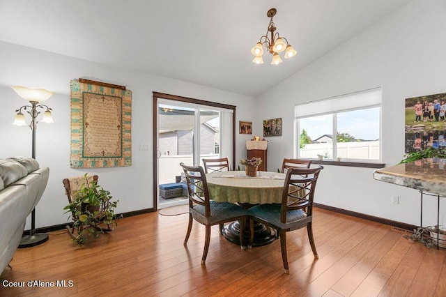 6487 W Covenant St, Rathdrum, ID 83858 - dining room featuring wood finished floors, a chandelier, and high vaulted ceiling