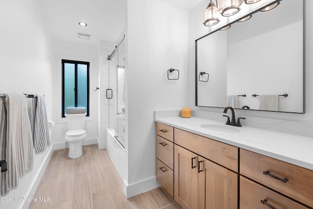 98 Chutes Ln, Sandpoint, ID 83864 - bathroom with vanity, shower / bath combination with glass door, wood finished floors, and recessed lighting