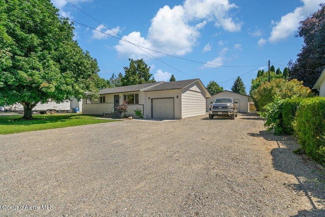 320 E Dakota Ave, Hayden, ID 83835 - view of front of home with dirt driveway and a garage