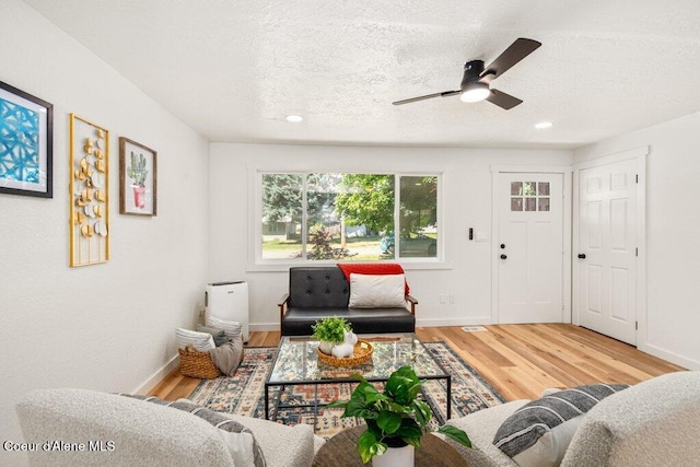320 E Dakota Ave, Hayden, ID 83835 - living room with wood finished floors, a ceiling fan, a textured ceiling, and recessed lighting