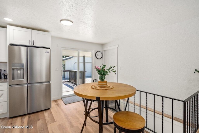 320 E Dakota Ave, Hayden, ID 83835 - dining space with a textured ceiling and light wood-type flooring