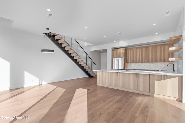 2492 N Atlas Rd, Coeur Dalene, ID 83814 - kitchen with stainless steel fridge, modern cabinets, light brown cabinets, open shelves, and light countertops