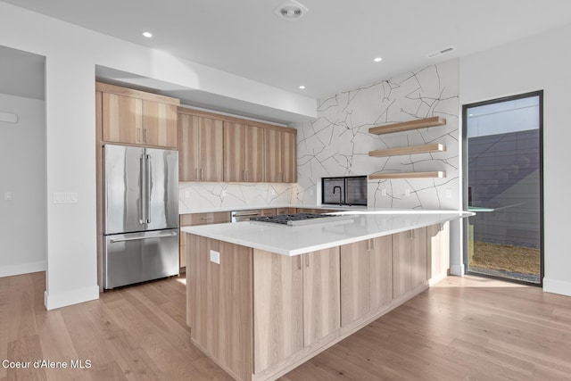 2492 N Atlas Rd, Coeur Dalene, ID 83814 - kitchen with appliances with stainless steel finishes, open shelves, light brown cabinetry, light countertops, and light wood-type flooring