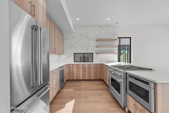 2492 N Atlas Rd, Coeur Dalene, ID 83814 - kitchen featuring high quality appliances, light brown cabinets, a peninsula, tasteful backsplash, and light countertops
