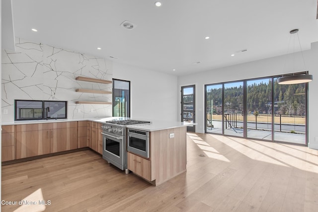 2492 N Atlas Rd, Coeur Dalene, ID 83814 - kitchen with light brown cabinetry, light wood-type flooring, recessed lighting, light countertops, and appliances with stainless steel finishes