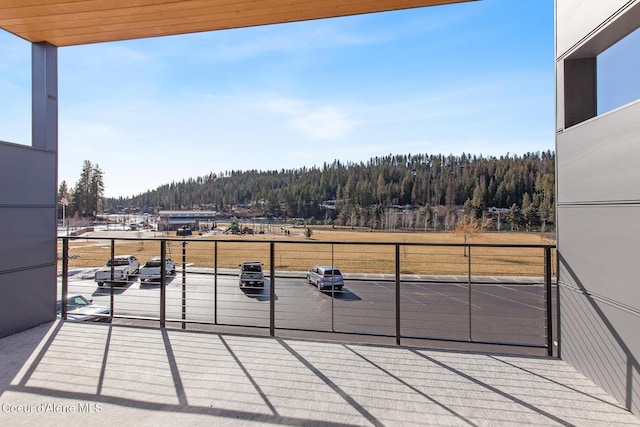 2492 N Atlas Rd, Coeur Dalene, ID 83814 - balcony featuring a wooded view