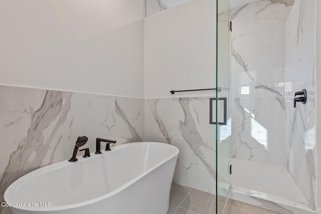 2492 N Atlas Rd, Coeur Dalene, ID 83814 - bathroom featuring a soaking tub, a marble finish shower, tile walls, and a wainscoted wall