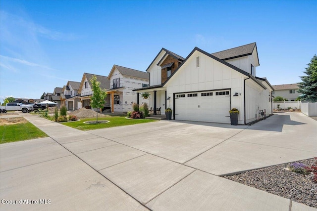 9137 N Raintree Ln, Hayden, ID 83835 - modern farmhouse featuring board and batten siding, a garage, driveway, and a residential view
