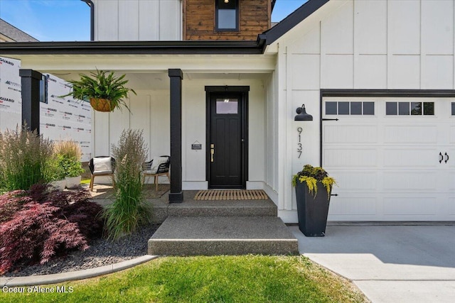 9137 N Raintree Ln, Hayden, ID 83835 - doorway to property with a garage, board and batten siding, and a porch