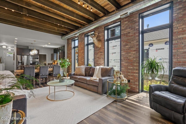9137 N Raintree Ln, Hayden, ID 83835 - common area featuring brick wall, a wood ceiling with exposed beams, and a towering ceiling