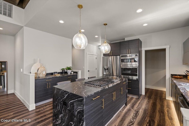 9137 N Raintree Ln, Hayden, ID 83835 - kitchen with appliances with stainless steel finishes, dark wood-style floors, modern cabinets, hanging light fixtures, and recessed lighting