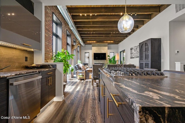 9137 N Raintree Ln, Hayden, ID 83835 - kitchen featuring appliances with stainless steel finishes, dark wood finished floors, open floor plan, decorative light fixtures, and dark stone counters