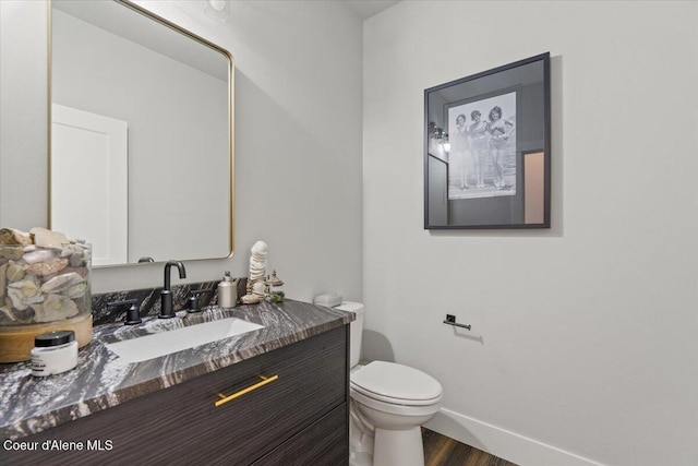 9137 N Raintree Ln, Hayden, ID 83835 - half bathroom with vanity and wood finished floors