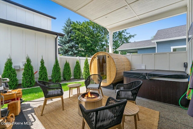 9137 N Raintree Ln, Hayden, ID 83835 - fenced backyard featuring a hot tub, an outdoor fire pit, and a patio area
