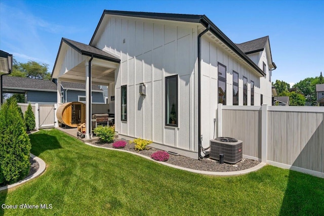 9137 N Raintree Ln, Hayden, ID 83835 - back of property featuring board and batten siding, a fenced backyard, and a gate