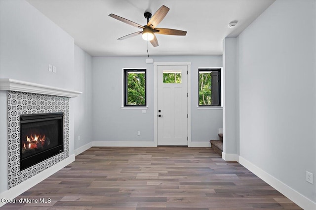9137 N Raintree Ln, Hayden, ID 83835 - foyer entrance featuring stairway, wood finished floors, ceiling fan, and a tile fireplace
