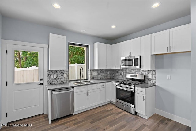 9137 N Raintree Ln, Hayden, ID 83835 - kitchen featuring appliances with stainless steel finishes, white cabinets, backsplash, dark countertops, and recessed lighting
