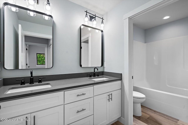 9137 N Raintree Ln, Hayden, ID 83835 - full bath featuring double vanity, wood finished floors, and shower / bath combination