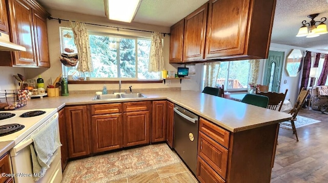 1150 Elm Dr, Saint Maries, ID 83861 - kitchen featuring stainless steel dishwasher, a peninsula, white range with electric cooktop, light countertops, and brown cabinets