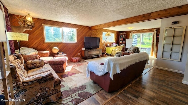 1150 Elm Dr, Saint Maries, ID 83861 - living area featuring a textured ceiling, wood finished floors, beamed ceiling, and wooden walls