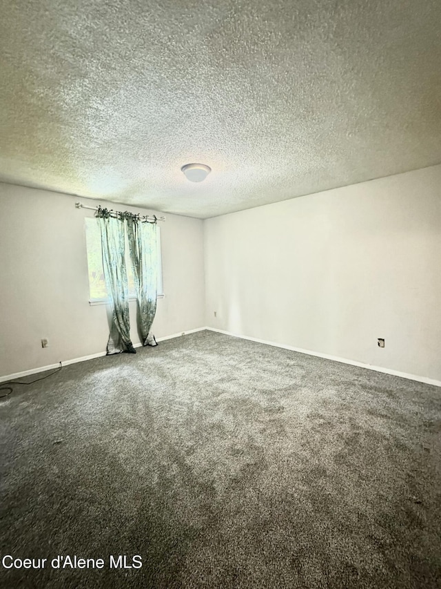 1150 Elm Dr, Saint Maries, ID 83861 - empty room with carpet floors and a textured ceiling