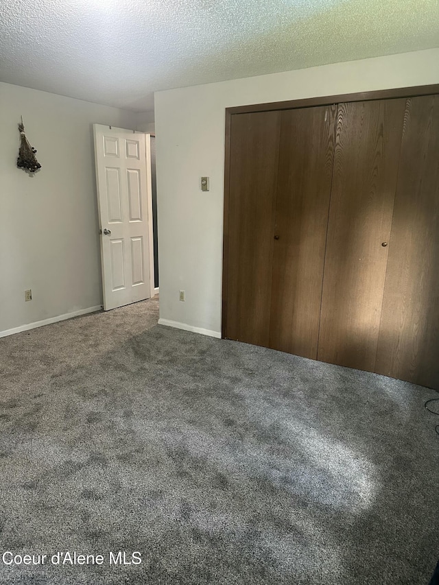 1150 Elm Dr, Saint Maries, ID 83861 - unfurnished bedroom with carpet, a closet, and a textured ceiling