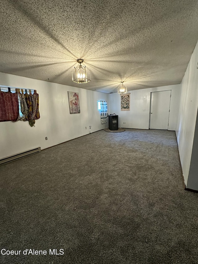 1150 Elm Dr, Saint Maries, ID 83861 - carpeted spare room with baseboard heating, a chandelier, and a textured ceiling