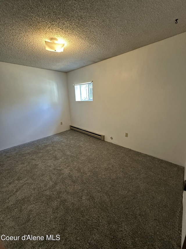 1150 Elm Dr, Saint Maries, ID 83861 - carpeted empty room featuring baseboard heating and a textured ceiling