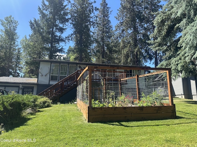 1150 Elm Dr, Saint Maries, ID 83861 - back of property with a vegetable garden, stairs, and a yard