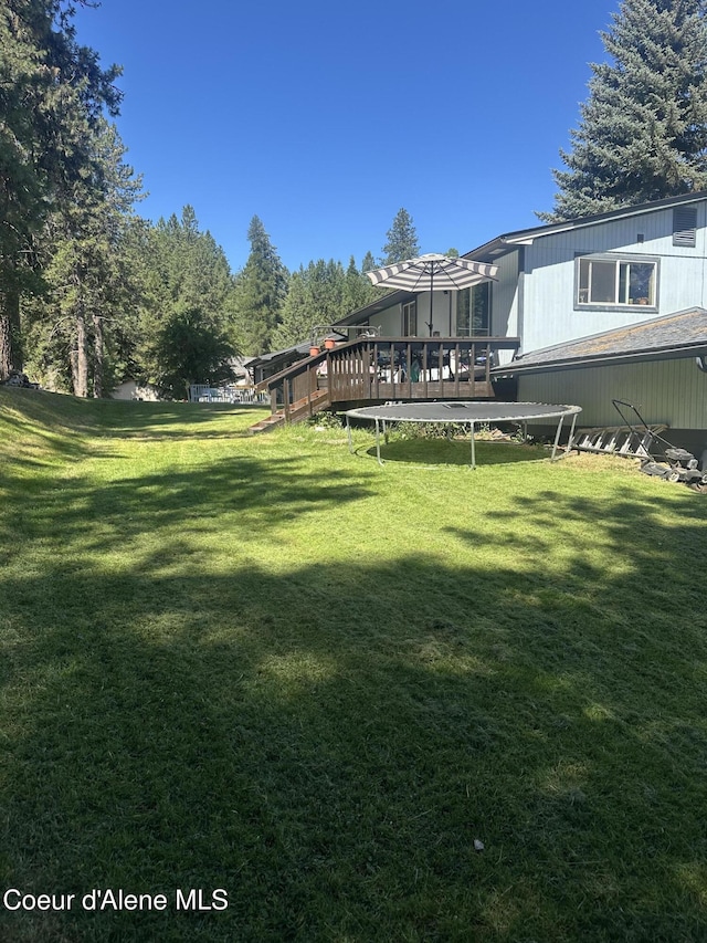 1150 Elm Dr, Saint Maries, ID 83861 - view of green lawn with a deck