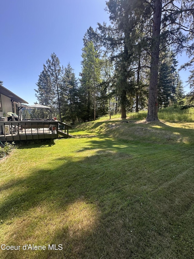 1150 Elm Dr, Saint Maries, ID 83861 - view of green lawn with a deck