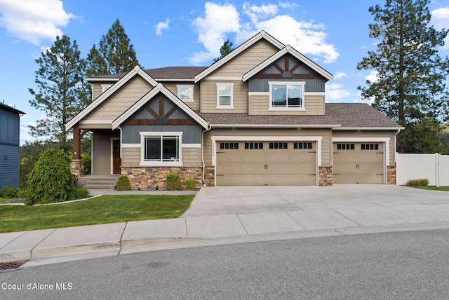 13408 E Copper River Ln, Spokane, WA 99206 - craftsman house with stone siding, concrete driveway, a shingled roof, and an attached garage