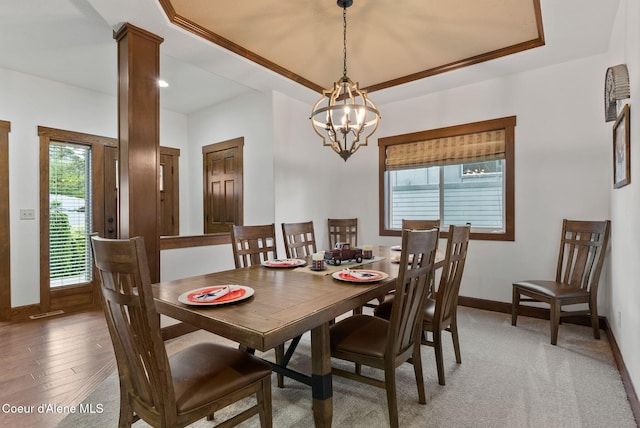 13408 E Copper River Ln, Spokane, WA 99206 - dining space featuring a chandelier, a raised ceiling, and decorative columns