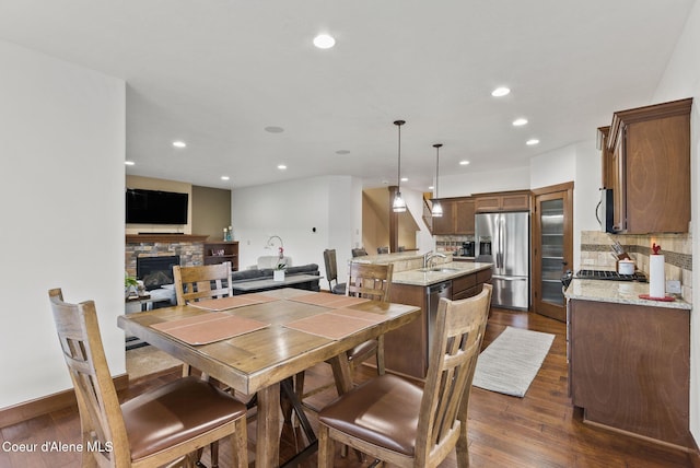 13408 E Copper River Ln, Spokane, WA 99206 - dining area with dark wood finished floors, recessed lighting, and a stone fireplace